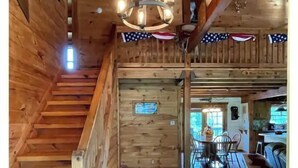 Un intérieur en bois avec un escalier menant à une salle à manger.
