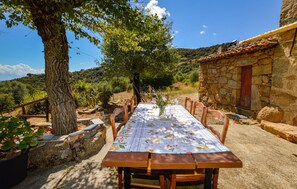 Enjoy a romantic meal for two in this charming outdoor dining area, complete with a beautifully set table and serene surroundings.