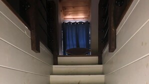 A staircase with white steps leading to a landing. - Quiet 2 story Cabin on 32 acres near eleven point river (Alton)