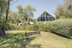 A modern building with a sign labeled 'WHITESANDS' in front.
