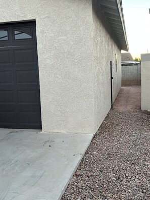 Stroll up the pathway to this charming home, where a garage door and driveway await.