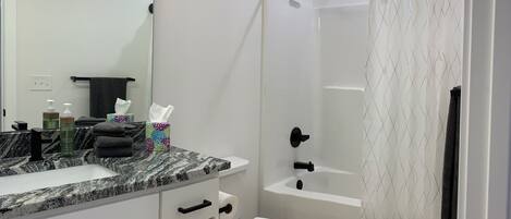 Combined shower/bathtub, hair dryer, towels, soap