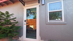A house with a glass door, a small window, and a wooden fence. - Queen. Minutes to Wilton drive. Private entrance and bathroom (Wilton Manors)