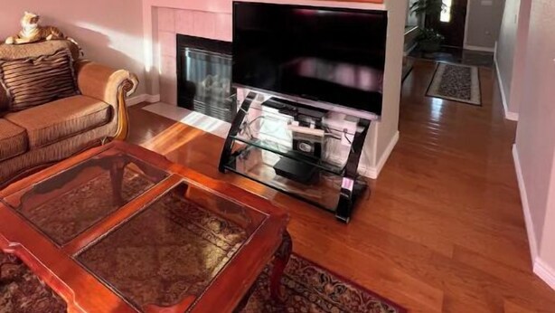 A living room with a fireplace, a sofa, a coffee table, and a television. - 3 bedroom house 5 minutes away from the airport in Colorado Springs all for you. (Colorado Springs)
