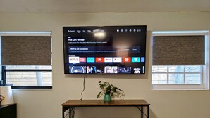 A flat-screen TV mounted on a wall displaying a movie title and a Wi-Fi connectivity message. - King. Minutes to Wilton Drive. Private entrance and bathroom. (Wilton Manors)