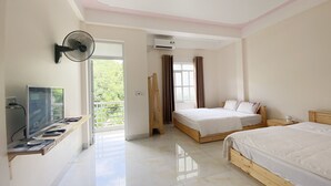 A bedroom with two beds, a TV, and a fan. - Sunny Bao Lac Homestay (Bao Lac)
