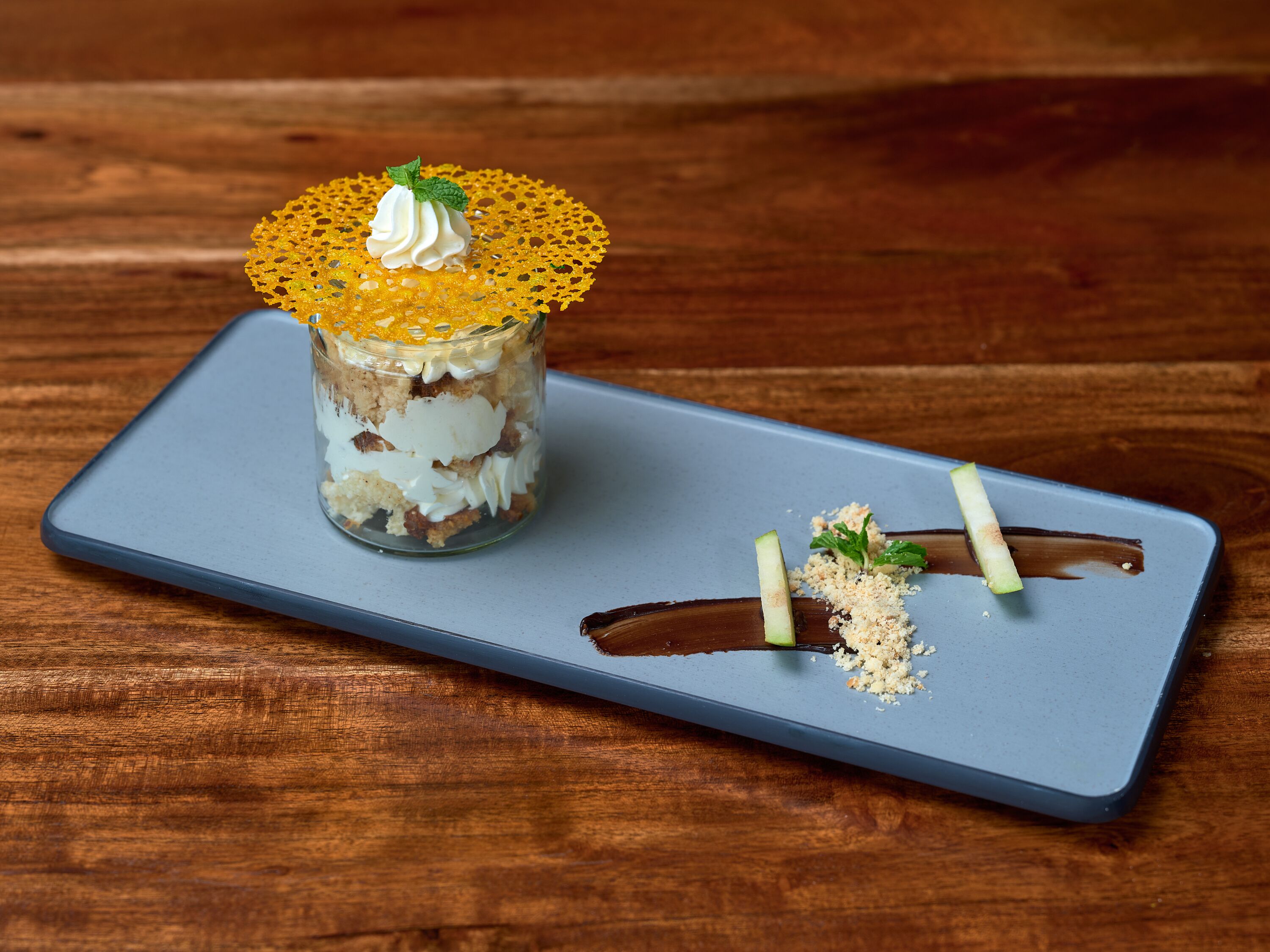A dessert on a blue tray with a wooden background.