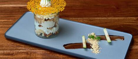 A dessert on a blue tray with a wooden background.