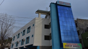 Un edificio con un cartel que dice 'SEVEN ELEVEN GUEST HOUSE' en la parte superior.