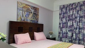 A hotel room with a bed, a nightstand, a vase with flowers, a painting on the wall, and a window with curtains. - Casa De Horyea , (Cairo)