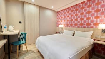 A hotel room with a bed, a desk with a chair, a water dispenser, and a patterned wall.