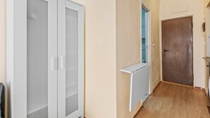 A hallway with a white wardrobe, a door, and a radiator. - Holiday Apartment 200 m from the Beach (Torrevieja)