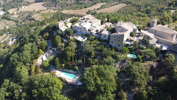 An aerial view of a large estate with multiple buildings, a swimming pool, and surrounding greenery. - Beautiful provencal house with a view, hanging gardens & a great swimming pool  (Montaulieu)