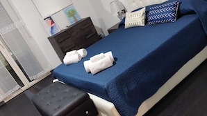 A bedroom with a bed, a nightstand, a dresser, and a bench. - KAM DELUXE 120 sqm bright suitable Groups,Families,Couples,Singles<br><br> (Calamonaci)