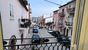 A residential street with houses on both sides, a clear sky, and parked cars. - KAM DELUXE 120 sqm bright suitable Groups,Families,Couples,Singles<br><br> (Calamonaci)