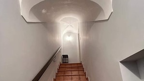 A staircase with a handrail and a light at the top. - KAM DELUXE 120 sqm bright suitable Groups,Families,Couples,Singles<br><br> (Calamonaci)