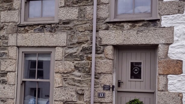 A stone building with two windows, a door, and a number plate. - Bijoux Cottage in Porthleven  5 mins walk  Beach/Harbour. Sleeps 2. Dog Friendly (Porthleven)