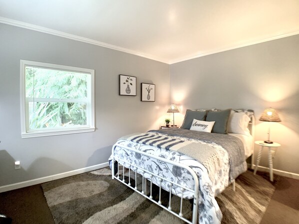 A bedroom with a bed, two bedside lamps, a window with blinds, and two wall-mounted pictures. - Beach & Redwoods 5mins from Unexpected Oasis (Crescent City)