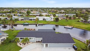 Un quartier résidentiel avec des maisons, une piscine et un quai.