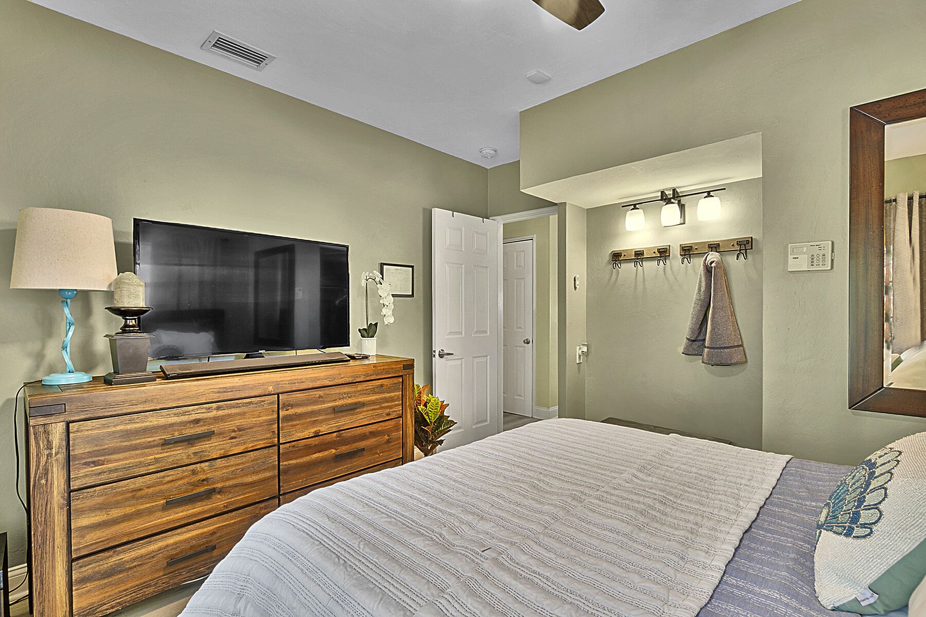The Queen Bedroom has access to backyard, a walk-in closet, and television. 