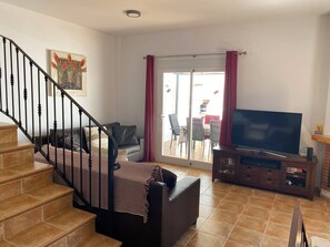 Smart TV, chimenea, libros, impresora