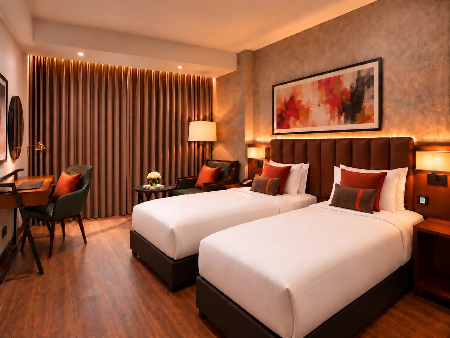 A hotel room with two beds, a desk, a chair, a lamp, and a painting on the wall.