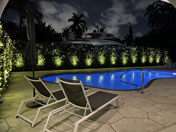 Relax by the pool, surrounded by a serene ambiance and comfortable lounge chairs.