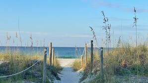 A sandy beach path leading to the ocean, surrounded by tall grasses and wooden posts. - Surf-N-Santa, 6 BR/4 BA, Private Pool with Hot Tub, West End PCB, Sleeps 18 (Panama City Beach)