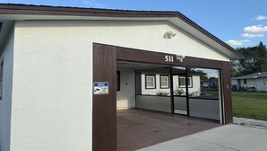 A building with a sign indicating 24-hour video surveillance. - Bella Is A Happy Place. (Lehigh Acres)