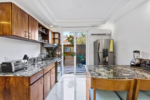Enjoy cooking in this kitchen with a sleek countertop, stainless steel appliances, and ample counter space.