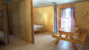 A wooden room with a large table and a bench. - Zubers - CA -H Cabin H (Concan)