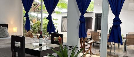 A modern dining area with a table, chairs, and a potted plant.