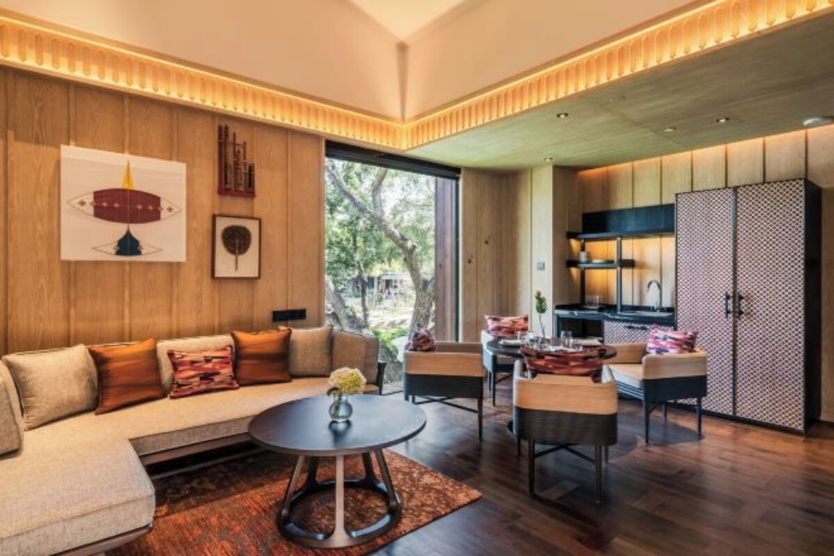 A modern living room with a sofa, coffee table, and dining area.