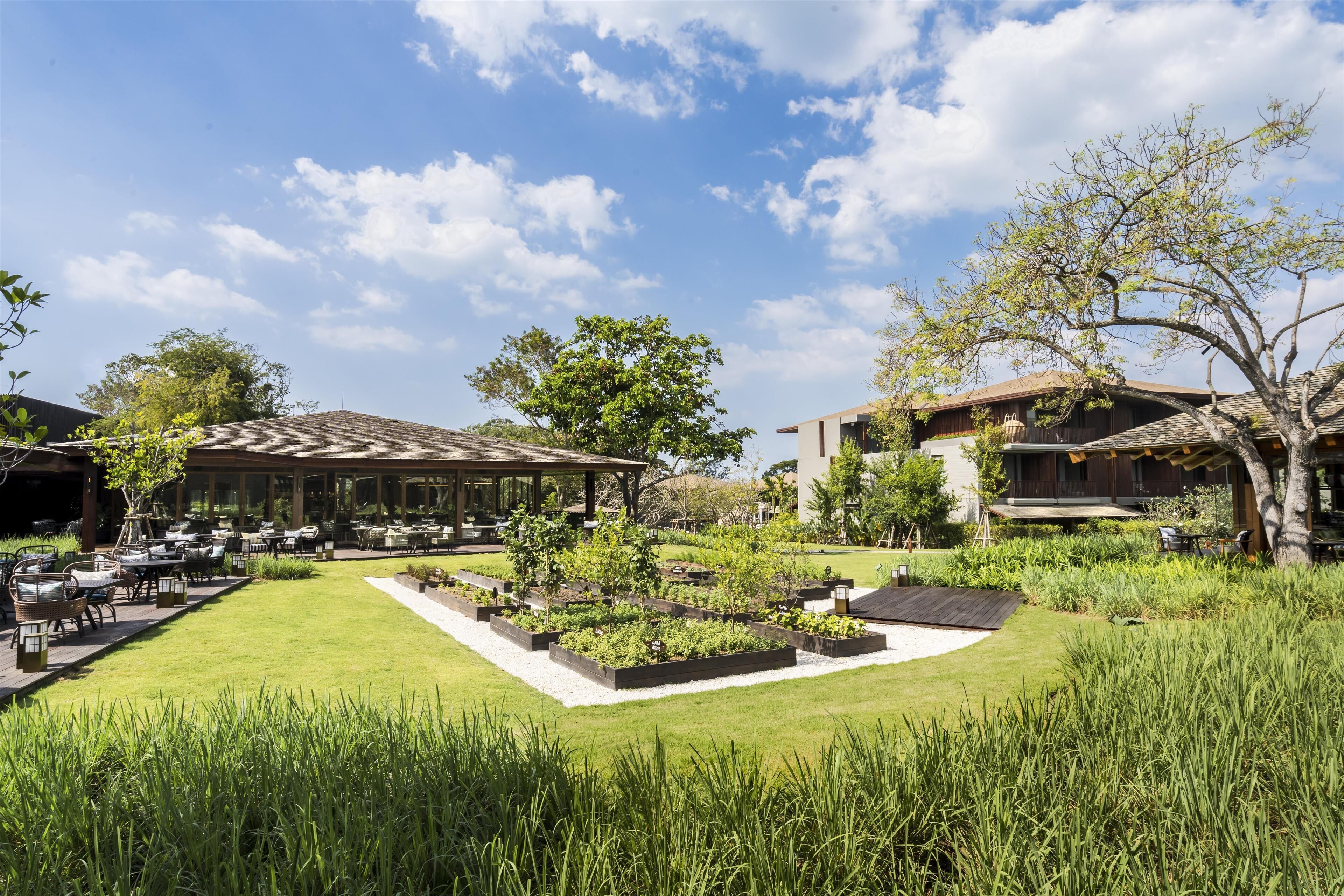 A well-maintained garden with a patio area, outdoor seating, and a gazebo.