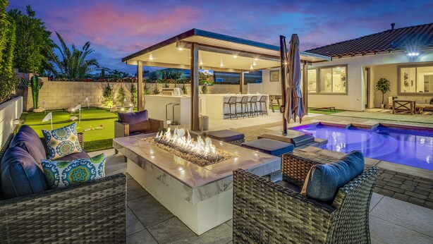 A poolside area with a fire feature, outdoor seating, and a covered patio. - The Montage: Luxury Resort Desert Retreat (Indio)