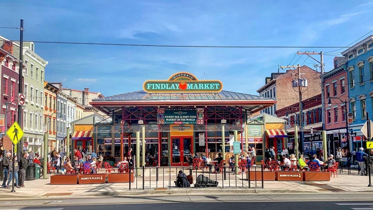 Findlay Market with a covered entrance, outdoor seating, and a pedestrian crossing.