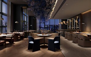 A modern interior with a central seating area, a bar, and a view of the cityscape. - Holiday Inn Express Chengdu Pidu by IHG (Chengdu)