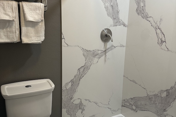 Separate tub and shower, rainfall showerhead, designer toiletries