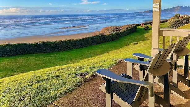 Une vue sur la plage avec des chaises et un panneau d’avertissement.