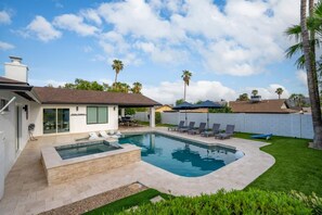 Wide view of the entire backyard featuring the sparkling pool, attached hot tub, and surrounding patio space. - 5BR Scottsdale Luxury Pool Home w Hot Tub (Scottsdale)