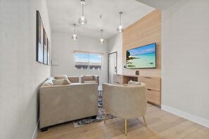 Presidential Suite, 1 King Bed, Jetted Tub | Living area | 55-inch Smart TV with satellite channels, TV - Aspire Inn Studios & Spas (Bellflower)