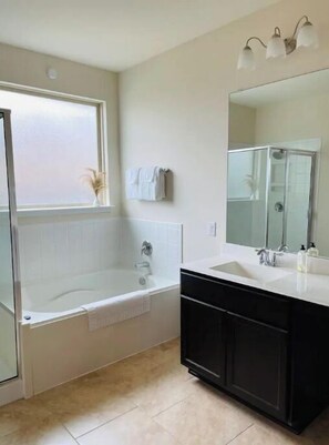 Combined shower/tub, hair dryer, towels, soap