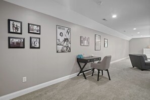 A room with a desk, chair, and framed pictures on the wall. - Waterfront Retreat w Dock, Firepit & Boat Access (Belhaven)