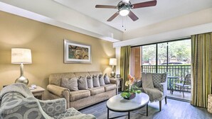 A living room with a sofa, armchairs, a coffee table, and a ceiling fan. There is a window with curtains and a view of the outside. - Disney Good Neighbor Resort Condo < 4 Mi to WDW! (Orlando)