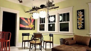A dining area with a table and chairs, a ceiling fan, and a chandelier. - boho noc GAME ROOM pets welcome king beds freeW/D (Amarillo)