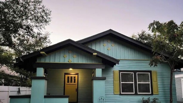 A two-story house with a front porch, a small front yard, and a mailbox. - boho noc GAME ROOM pets welcome king beds freeW/D (Amarillo)