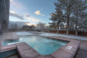 A hot tub with a view of a snowy landscape and a wooden deck. - Spacious Park City Studio minutes from all mountain resorts & Main St (Park City)