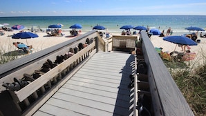 A wooden boardwalk leading to a beach with several blue umbrellas and people relaxing. - New Low Fall/Winter Prices! 2BR2BA Beauty in Gulf Shores Crystal Tower 608 (Gulf Shores)
