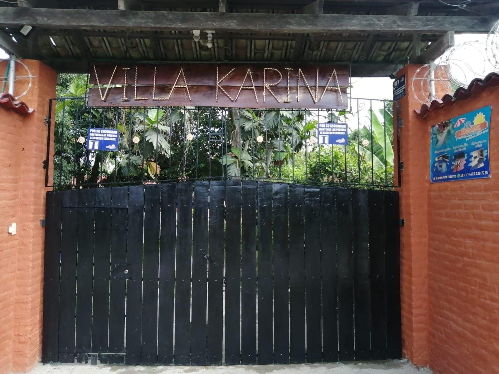 Ein verschlossenes Tor zum Anwesen Villa Karina, mit einem Schild darüber.