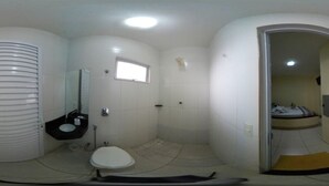 A compact bathroom with a toilet, sink, and shower. - hotel e motel ape goiania anel viario (Goiânia)